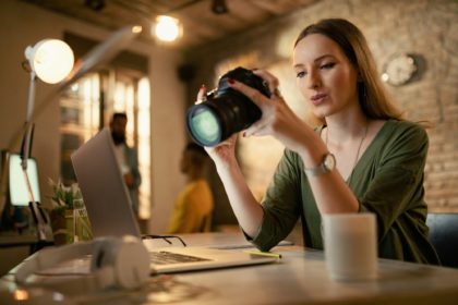 Female photographer checking images on digital camera in a studio.